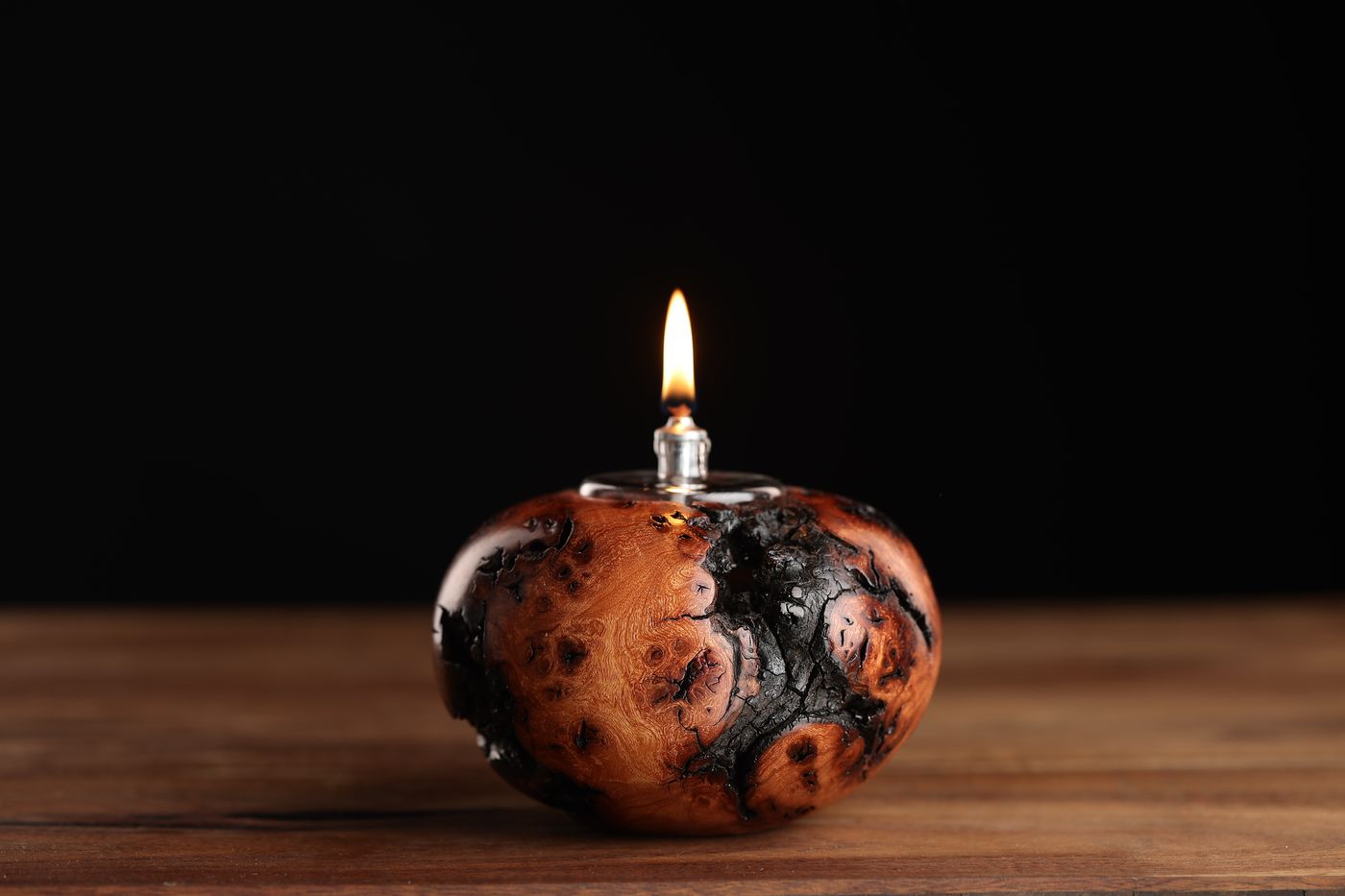 KO: a small, dense dark juniper burl oil lamp, lit