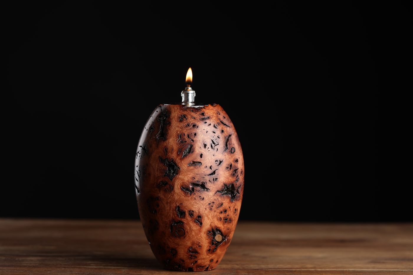 Leopard: a tall upright juniper burl oil lamp spotted with burl eyes, lit